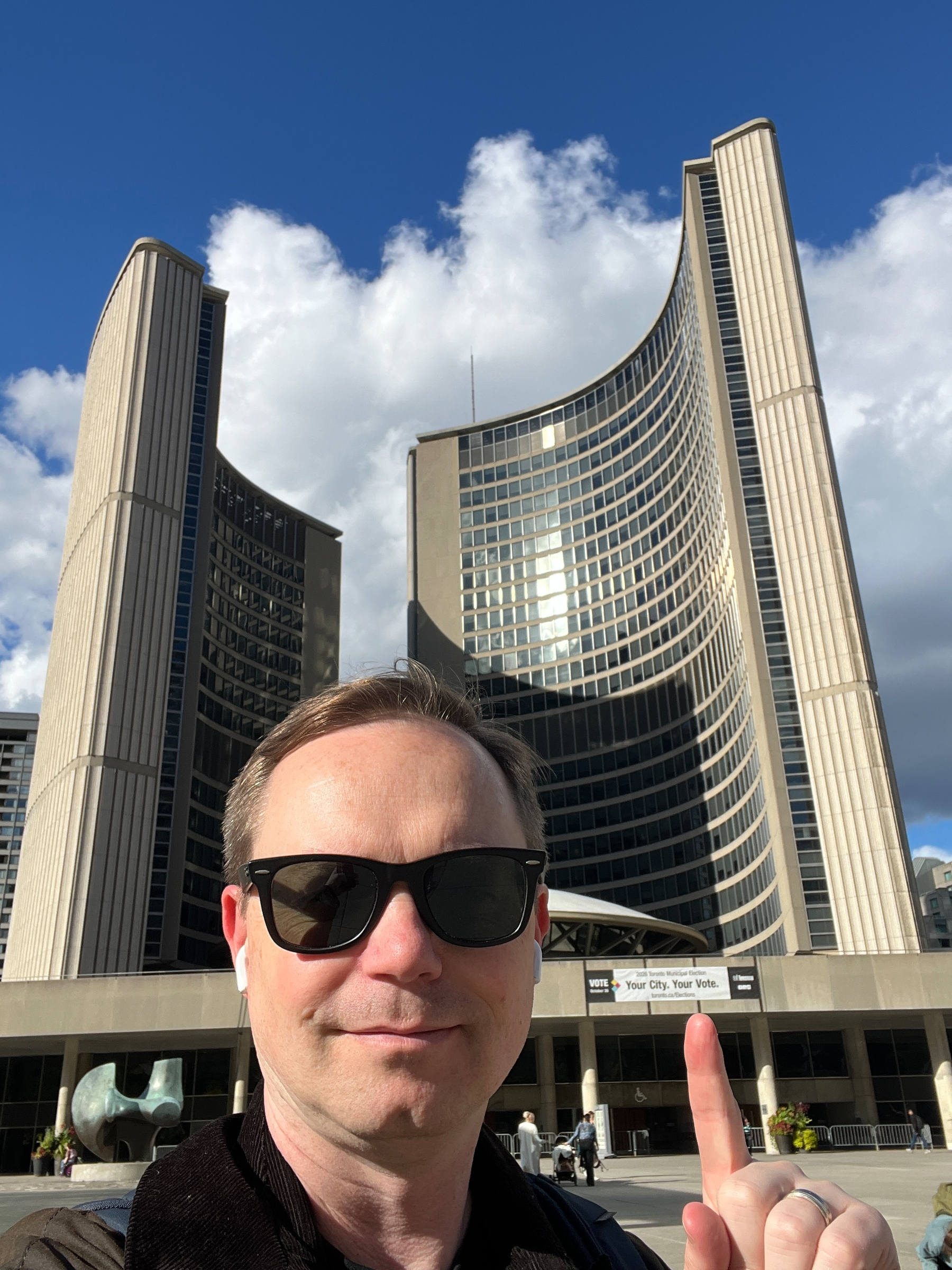 Chad selfie in front of the curvy Toronto City Hall which has been the Bad Guy lair in many films