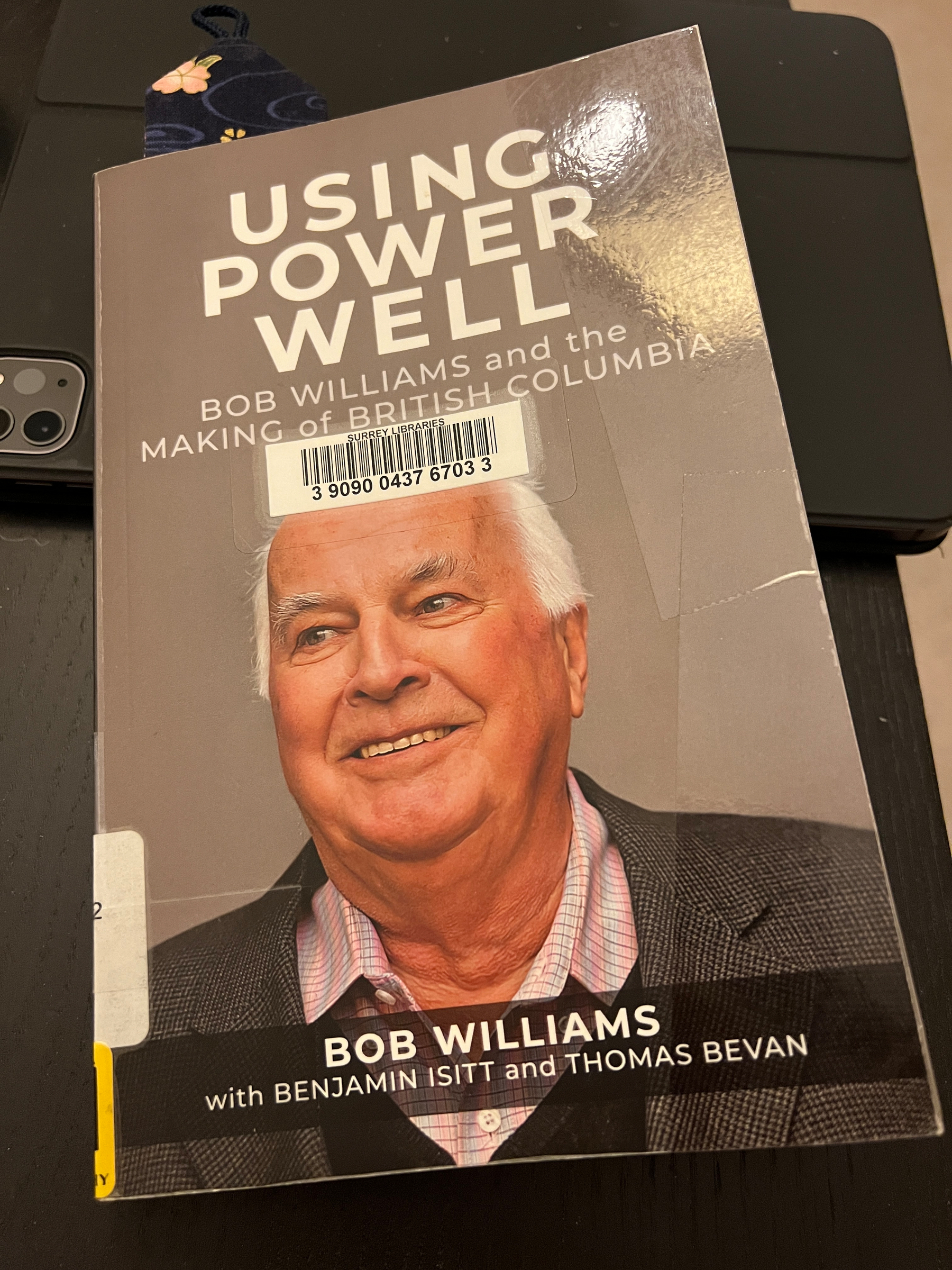 The book sitting on an iPad on a side table