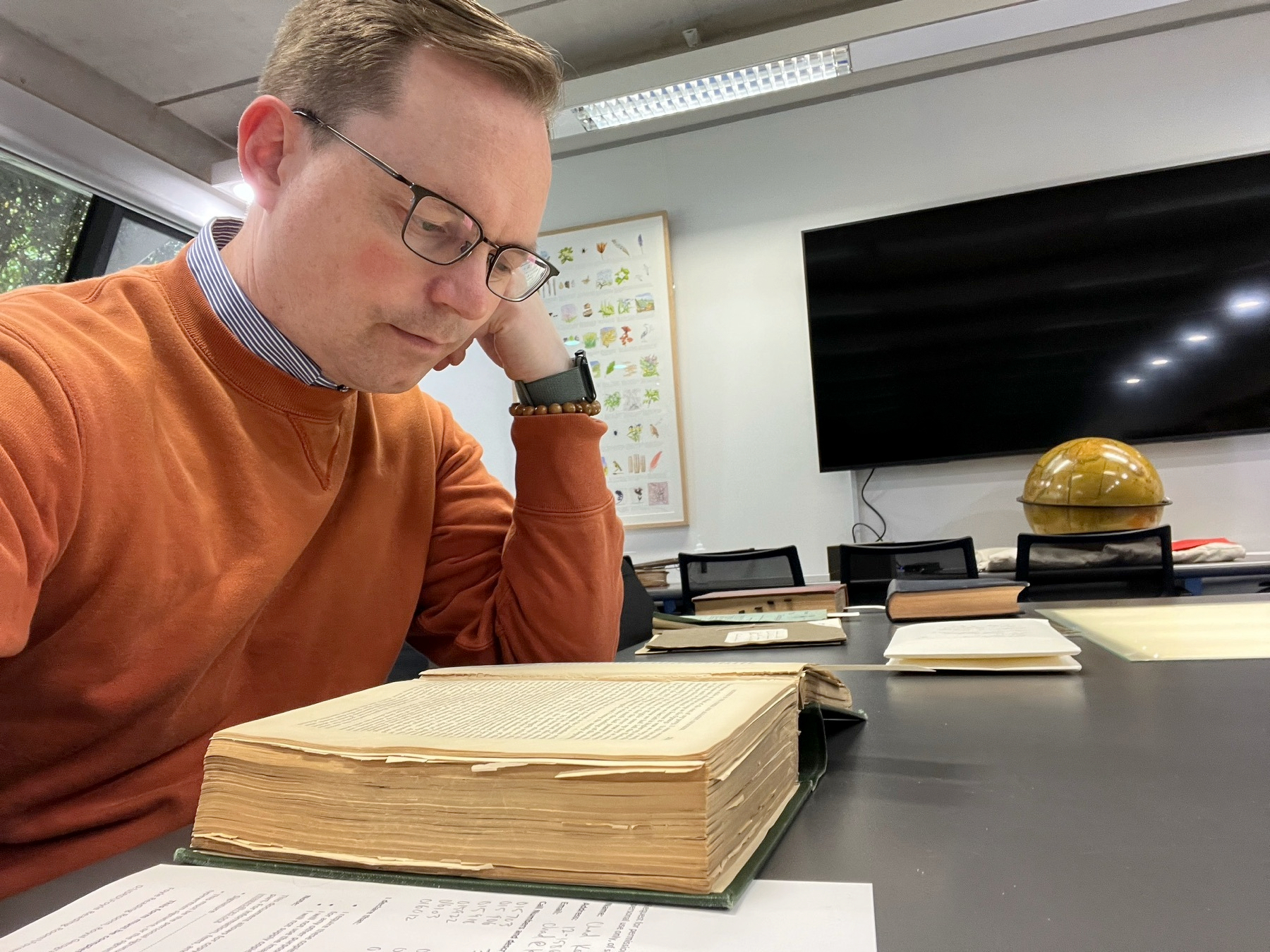 Chad reading a book at a table