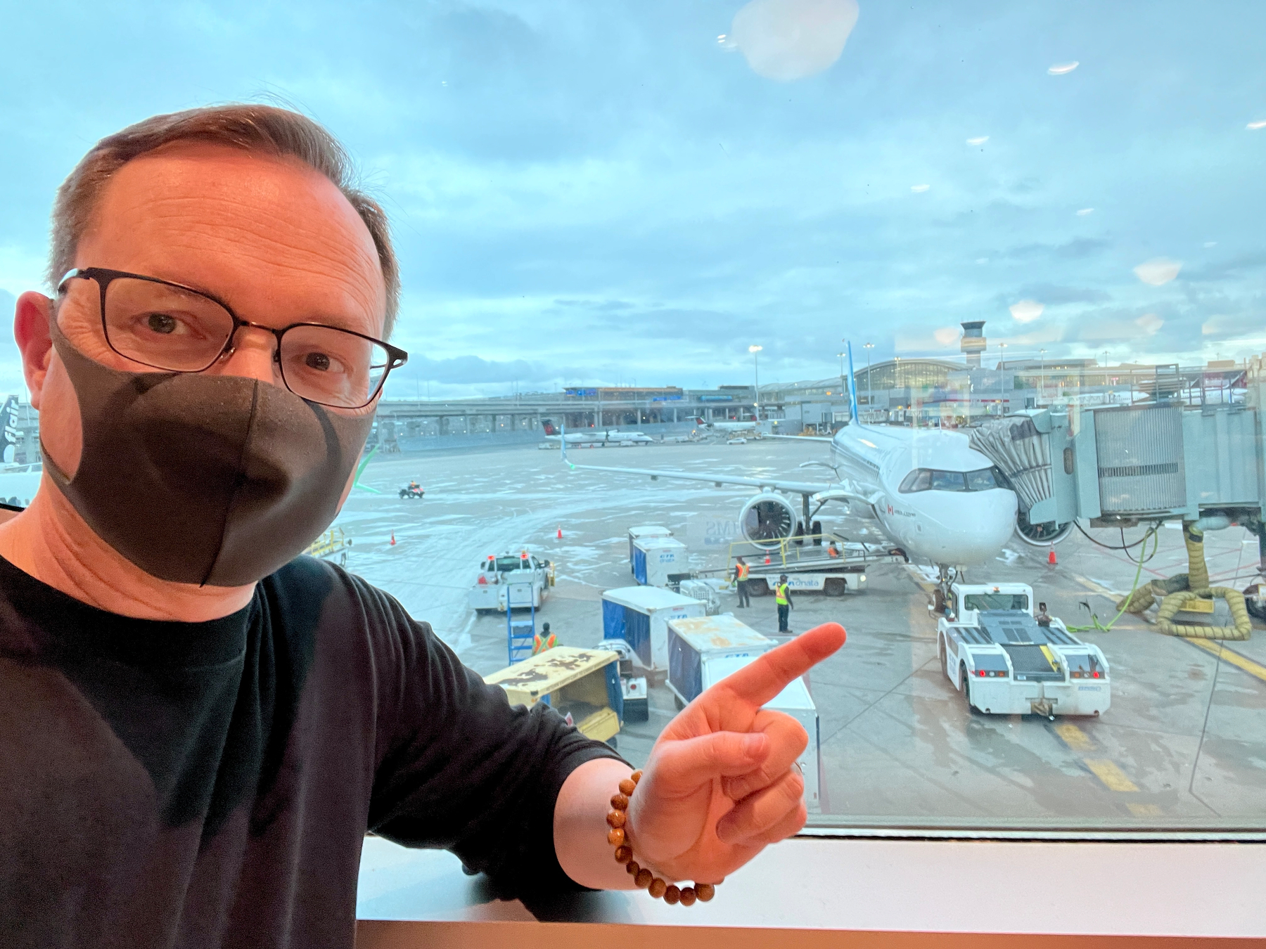 Chad points to his plane from the gate, all checked in and ready to fly