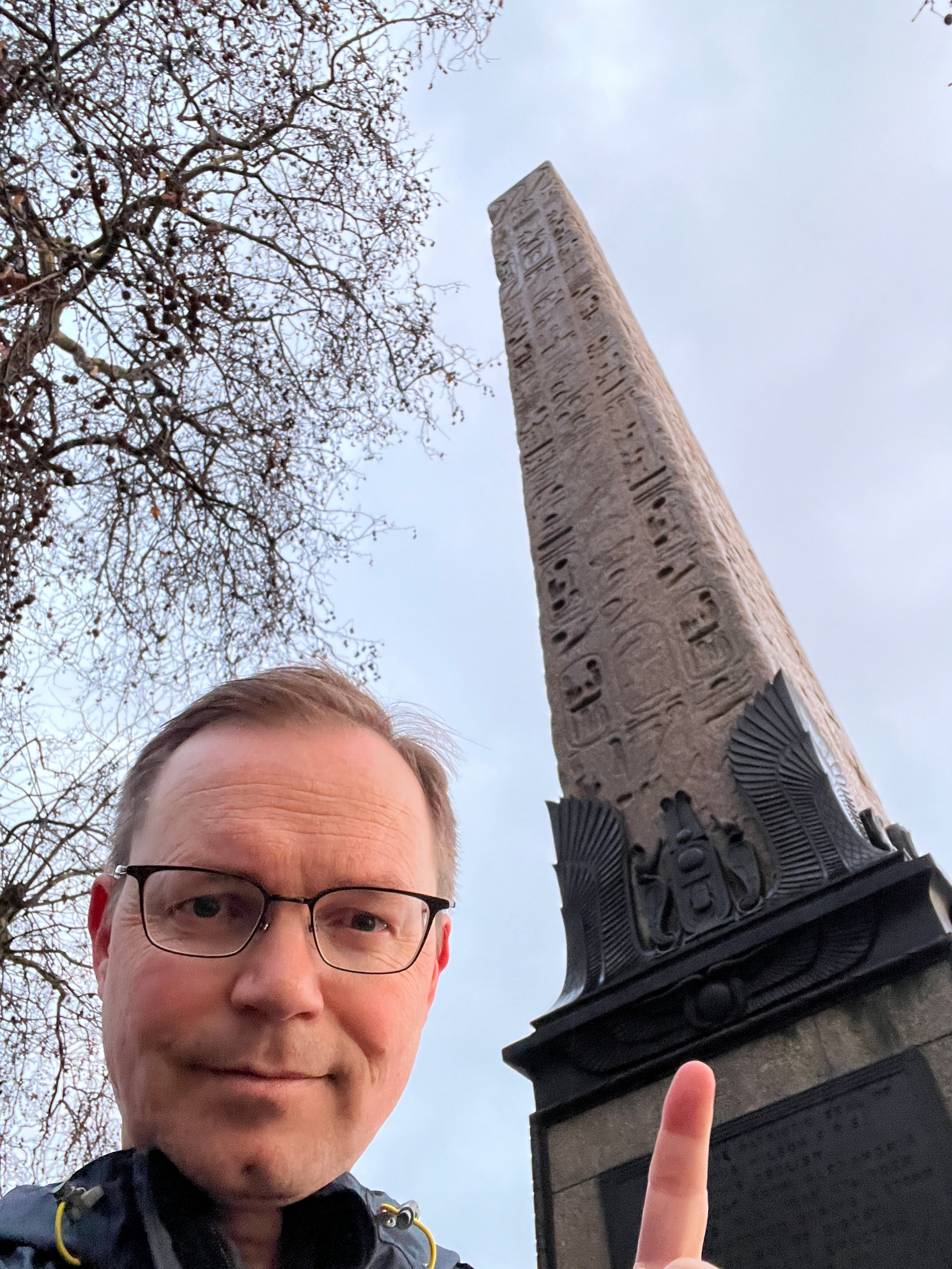Chad points at an obelisk