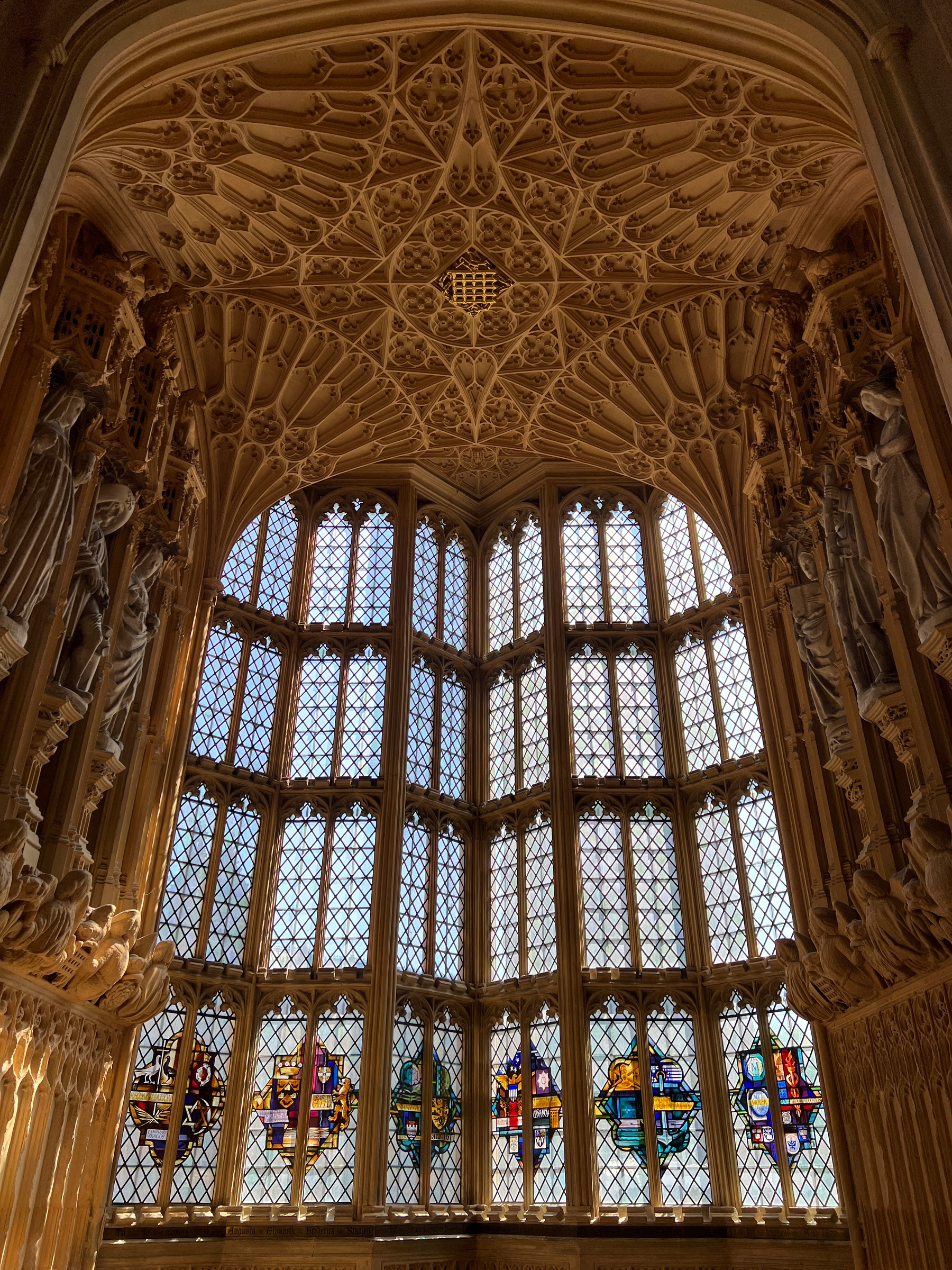 A corner window with complex designs. It’s like this place was designed by an alien spider race