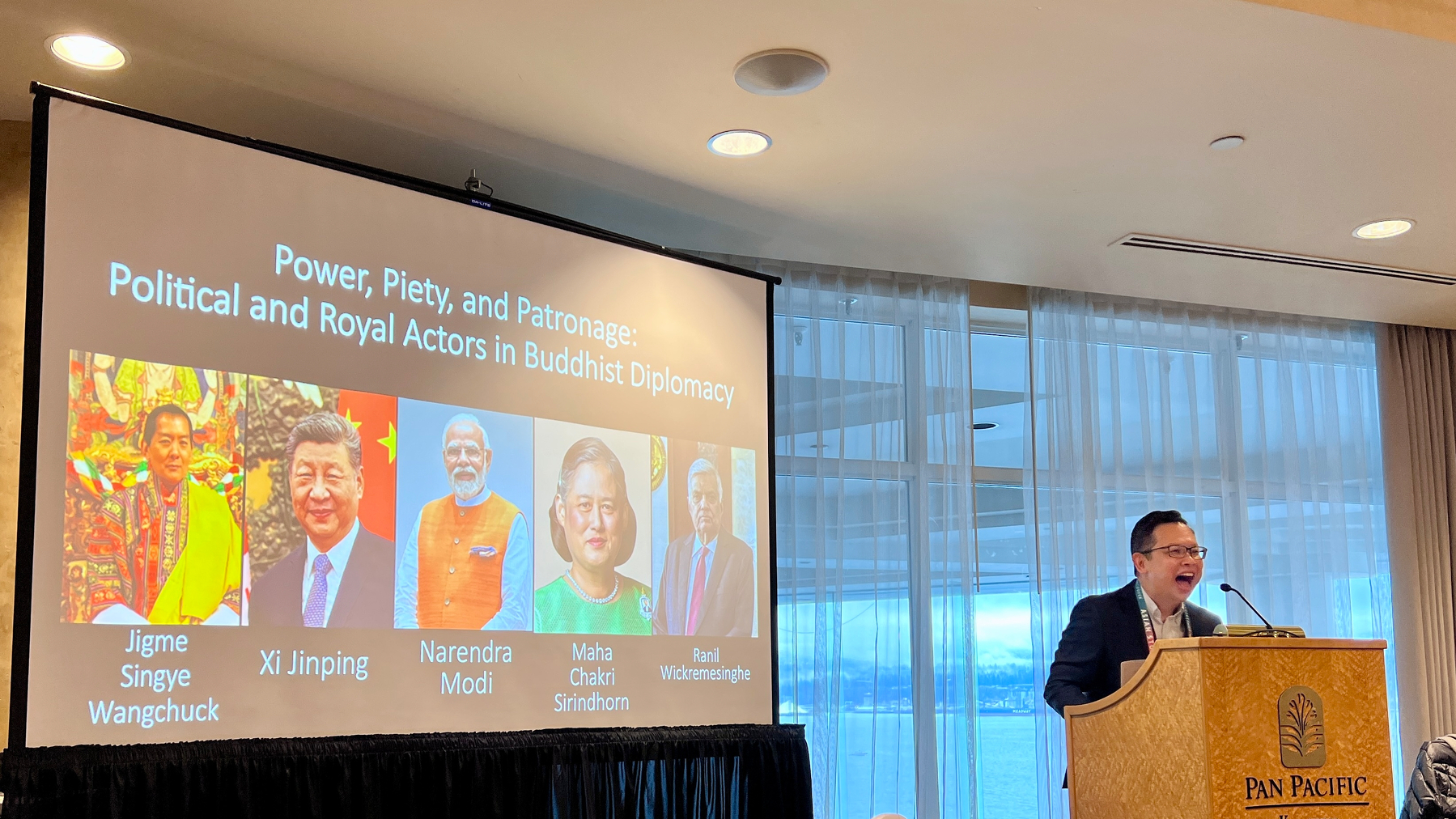 Jack Meng-Tat Chia at a podium with a slide: “Power, Piety, and Patronage: Political and Royal Actors in Buddhist Diplomacy”
