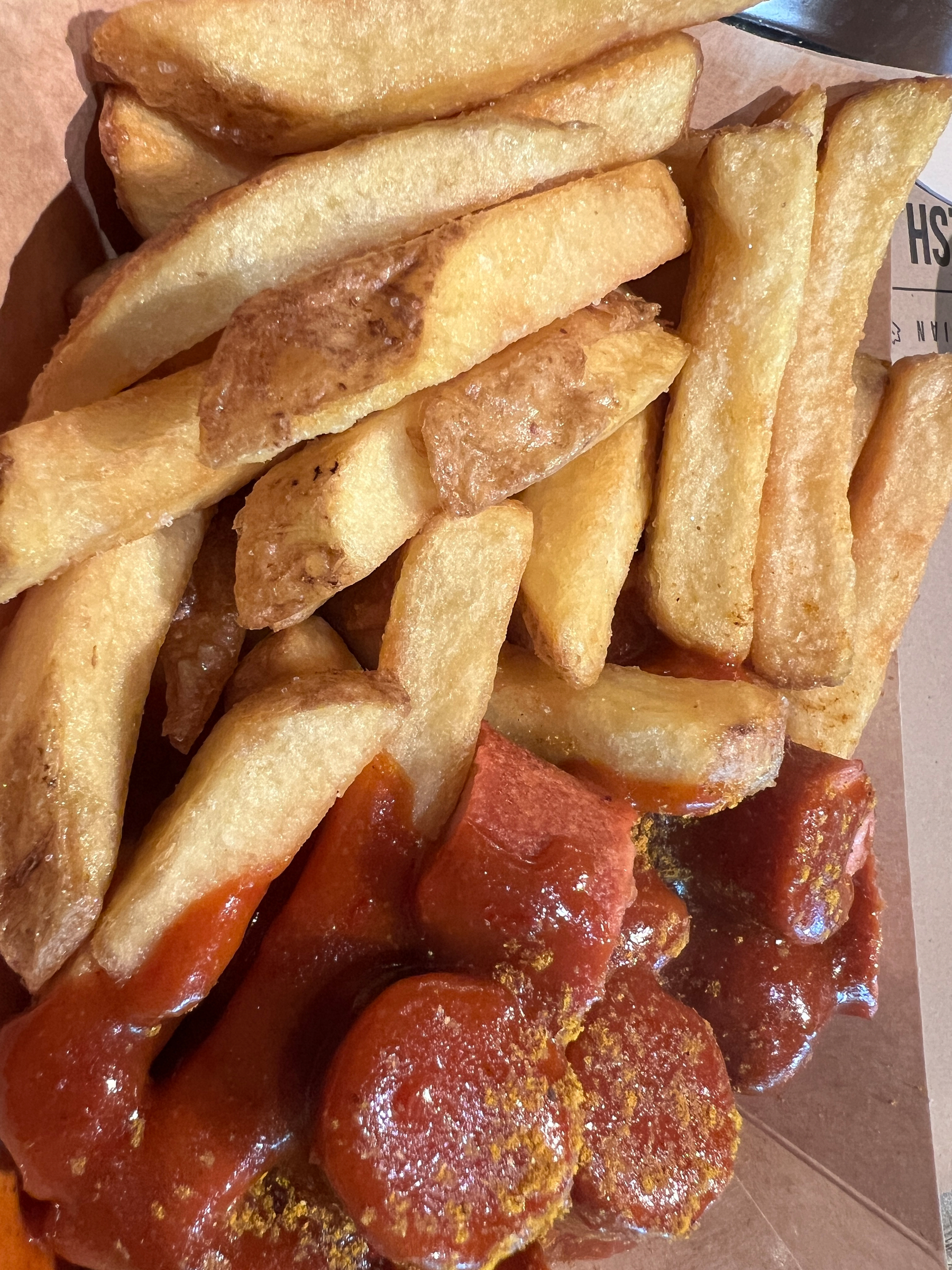 Closeup of fries and currywurst