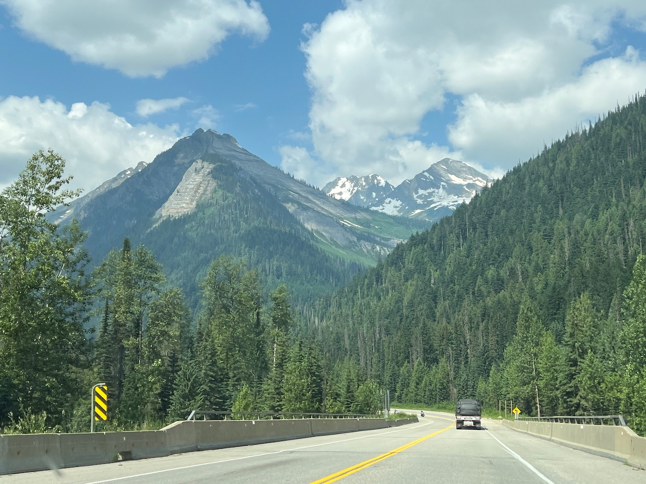 Snow capped peaks over a highway