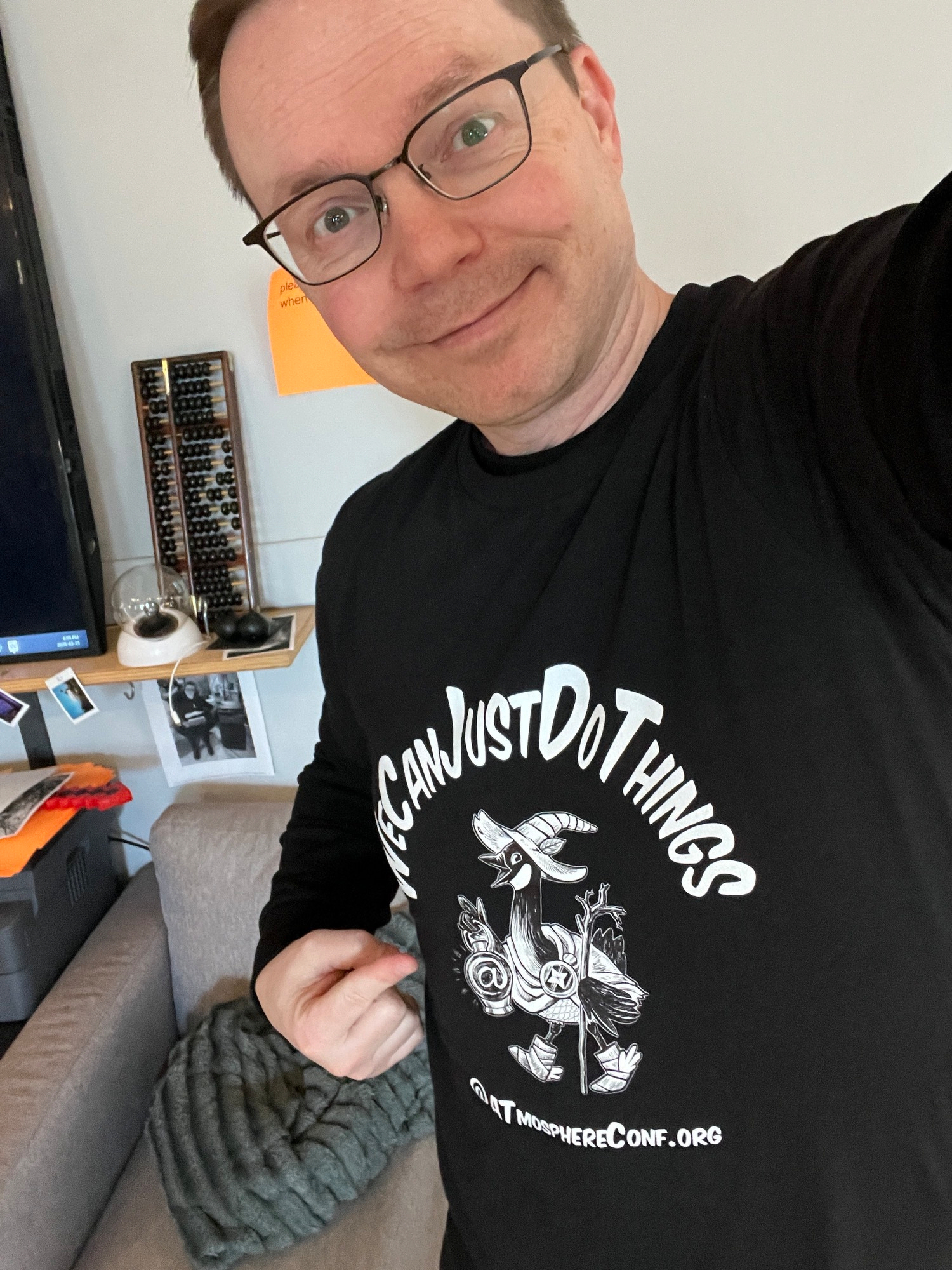 Chad selfie pointing to his conference shirt with the conf catchphrase "We can just do things"