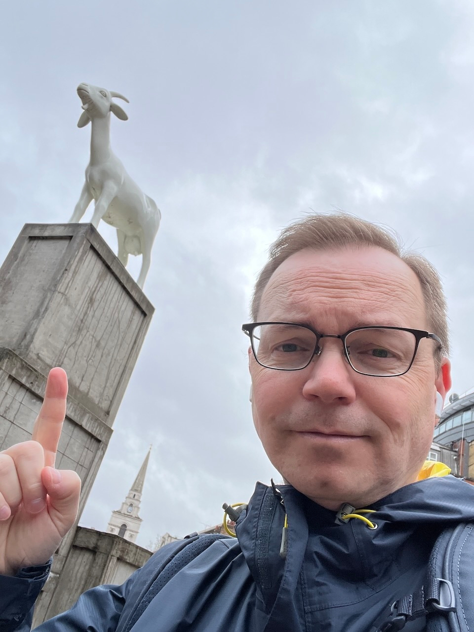 Chad points up to a statue of a goat near Spitalfields Market