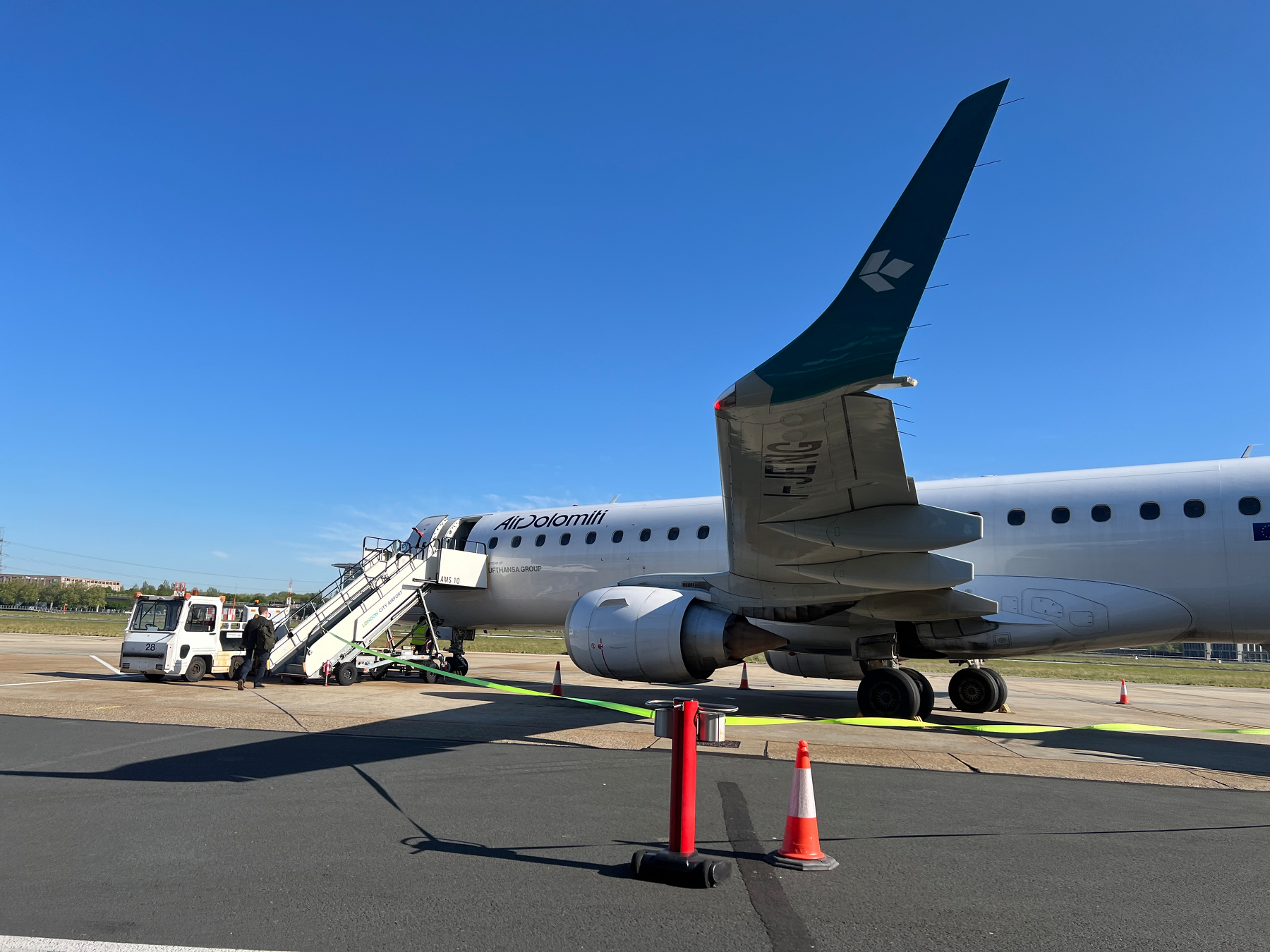 Under the wing of a plane on the tarmac 