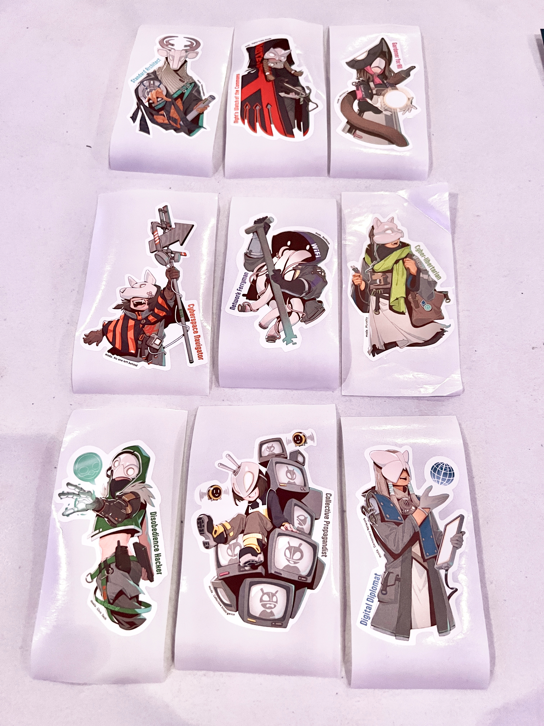 Stickers of mascots from the Ministry of Digital Affairs including Disobedience Hacker, Standards Architect, and Gardener for All