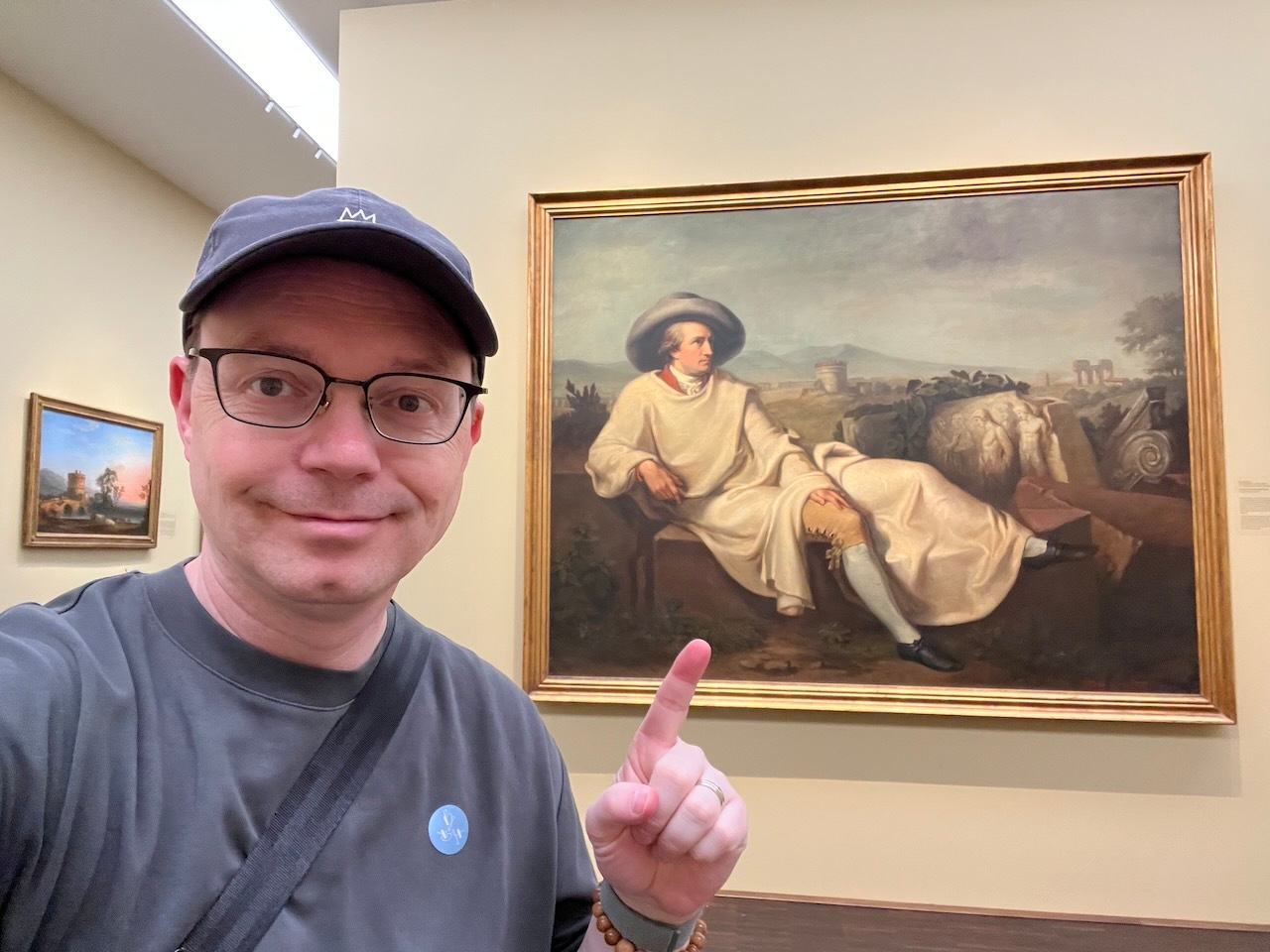 Chad posing with a portrait of Goethe earlier in his life