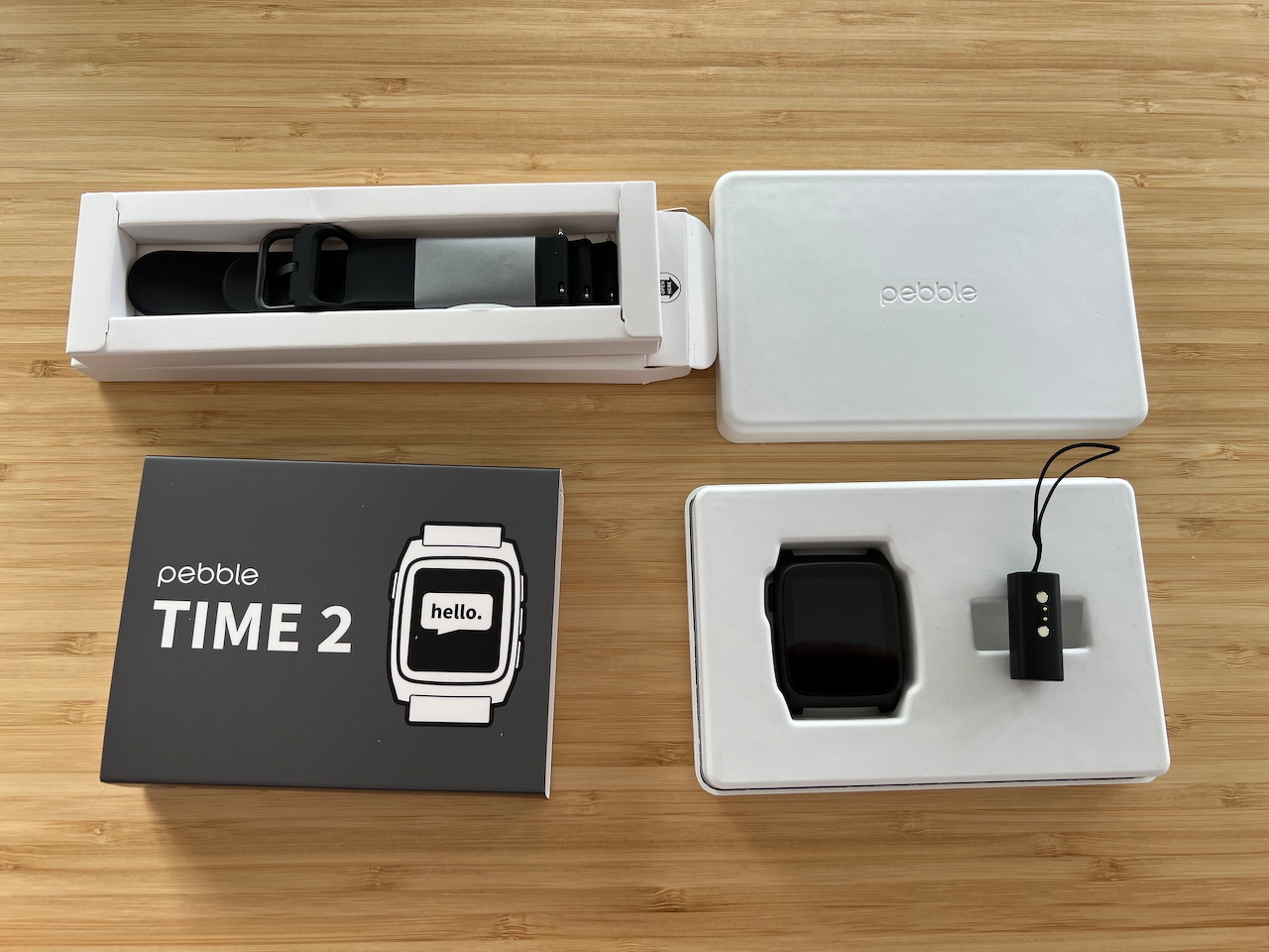 Opened Pebble Time 2 and watch strap boxes revealing plain black watch and strap