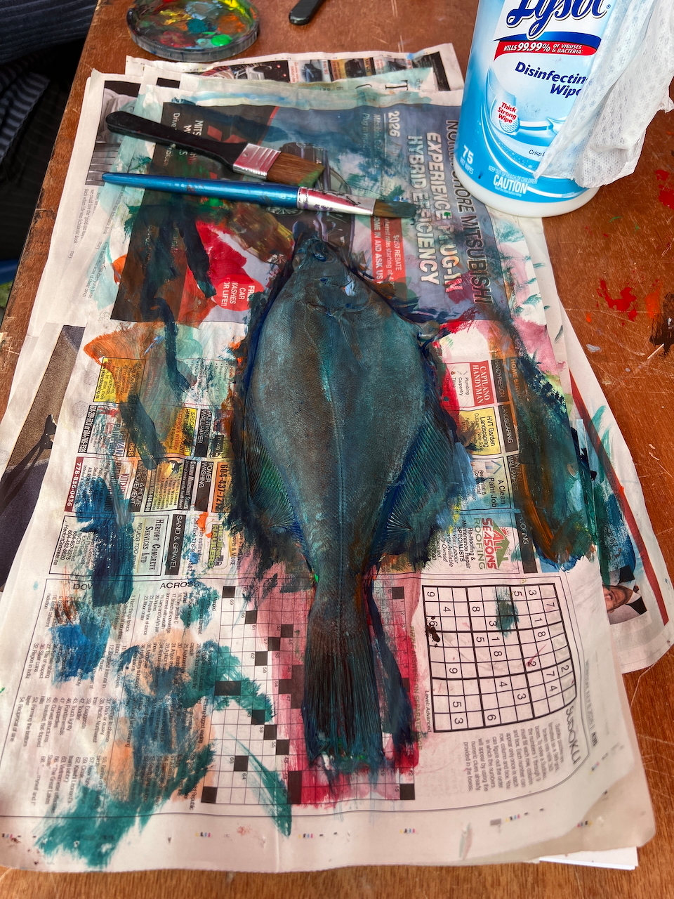 a real fish covered in paint to be used for an impression