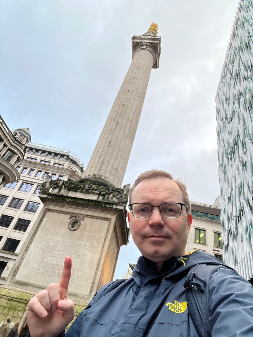 Chad points at a pillar set on a large monument