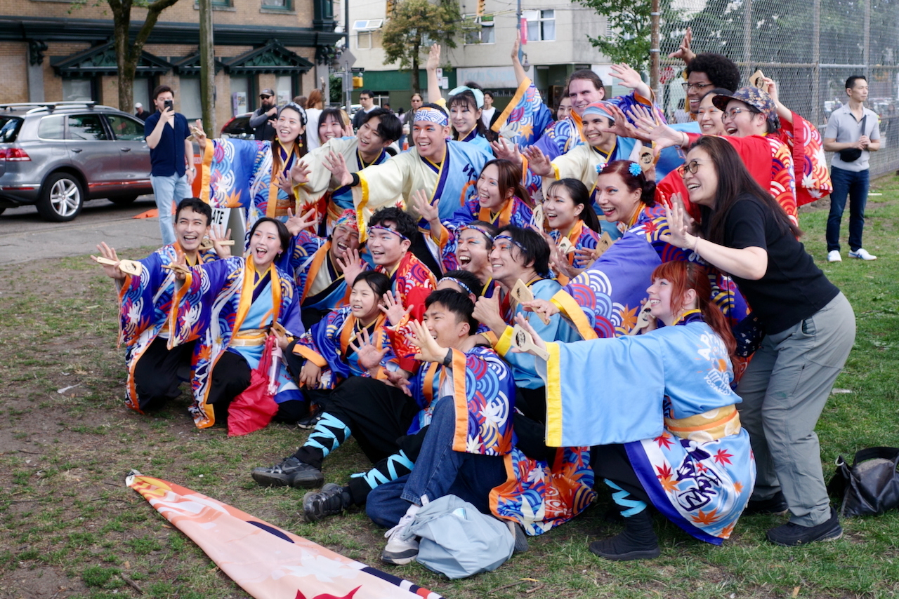 colourful dance group posing for a group photo