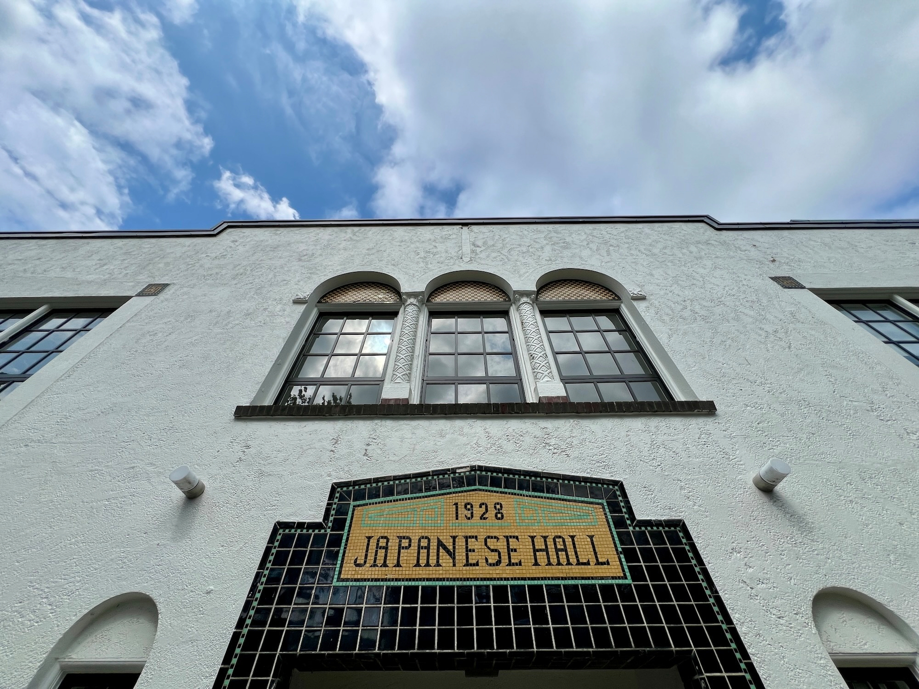 Wide angle of the entrance of the building with mosaic text "1928 Japanese Hall"