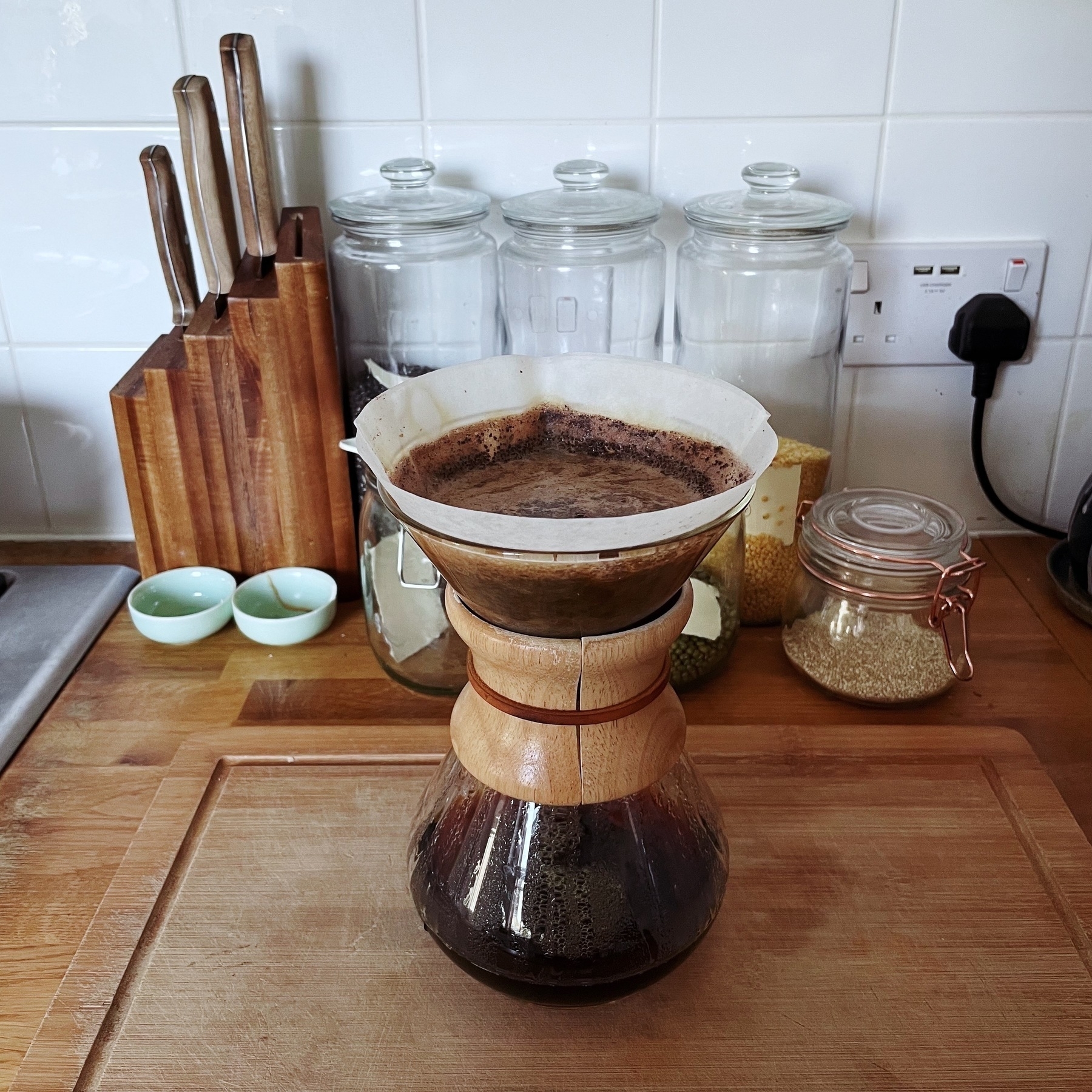 Coffee being made in a conical glass dripper.