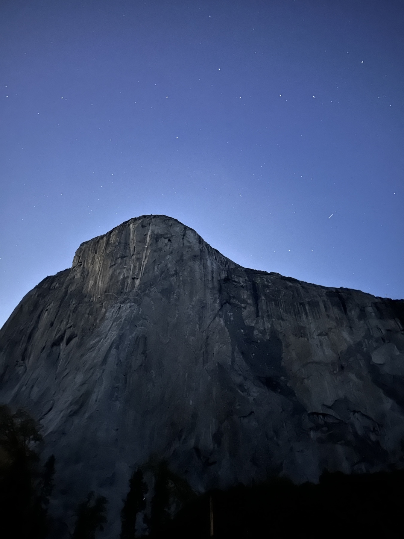 The Big Dipper pointing down at El Capitan, stars above the biggest rock on Earth, after sunset, with the flash of a climber’s headlamp at Camp 6, a mere 4 pitches from from the top.