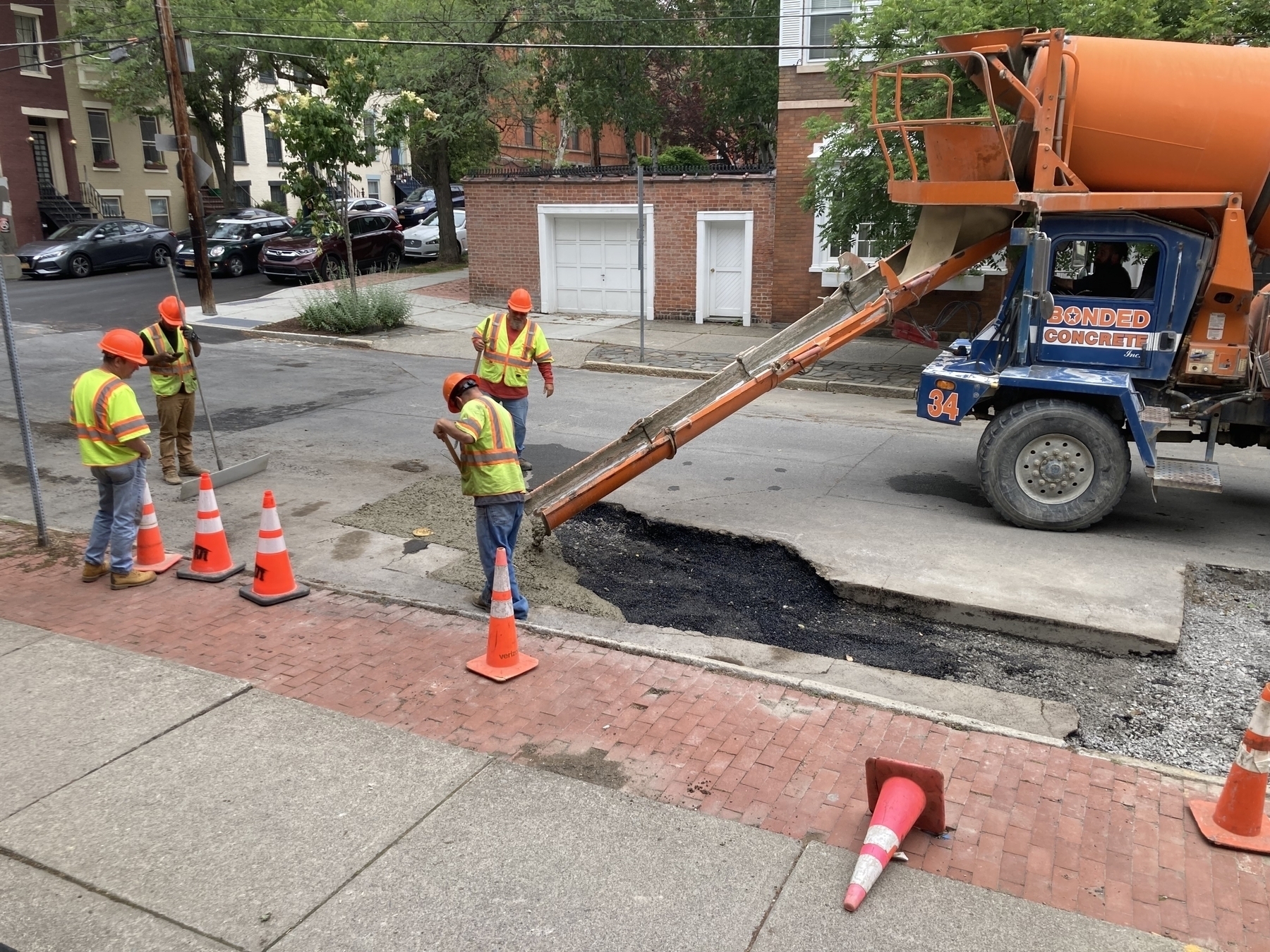 Pouring concrete to fill in where a new gas line was laid. 