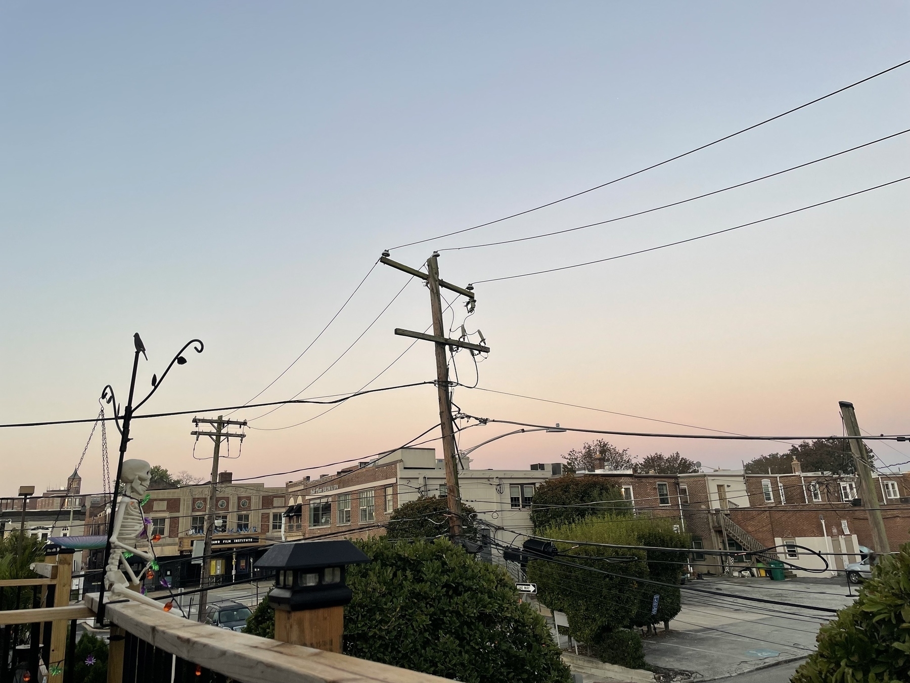 A blush of blue-pink sky on the horizon, past the telephone poles & power lines. No sun visible yet. &10;