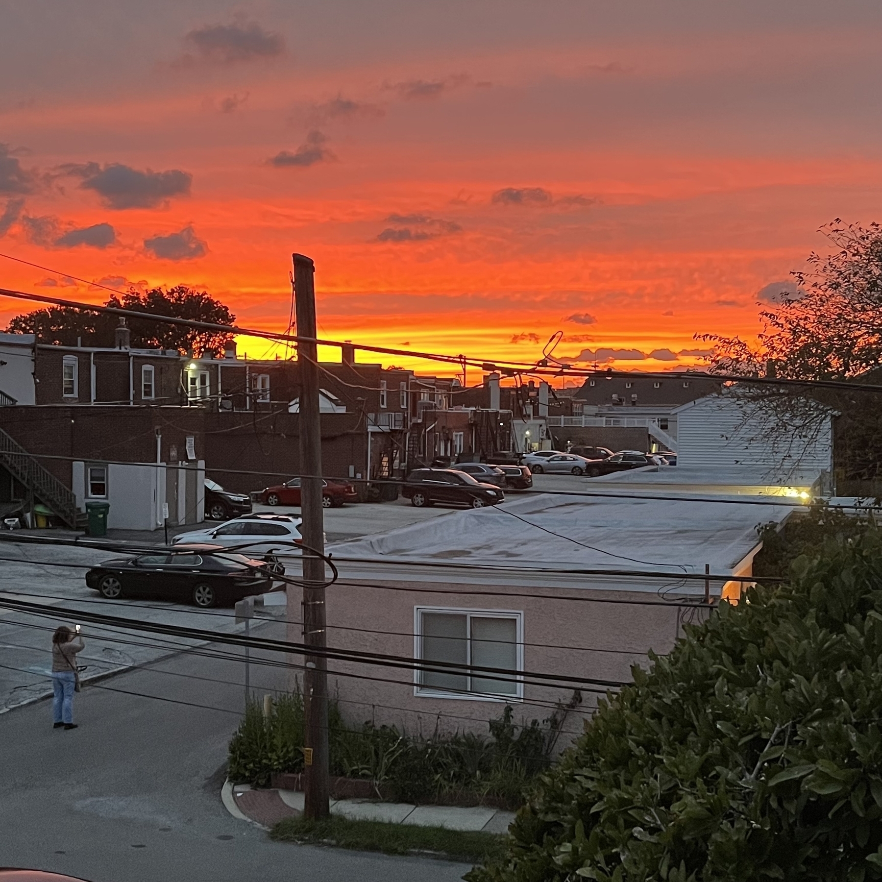 Vibrant sunset with a paint like swipe of deep yellow across  orange-red clouds 