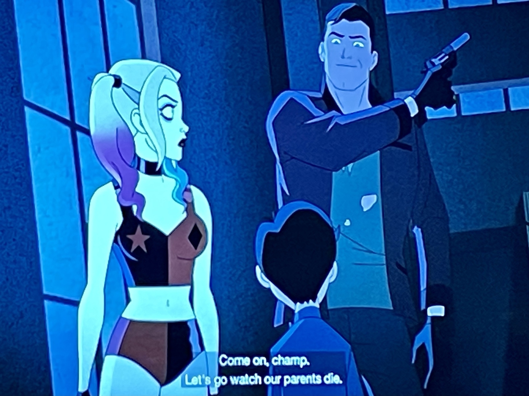 Frame from Harley Quinn animated show. Harley is in Bruce Wayne’s subconscious , witnessing adult Bruce telling little Bruce “come on champ, let’s go watch our parents die!”  (Scene continues in next picture) 