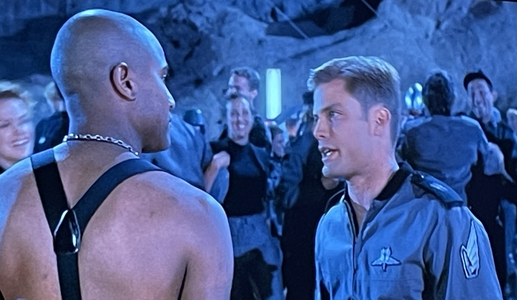 Still from the movie, as described in the post — all characters are at a dance party but one white man in gray and a Black man wearing what appear to be overall straps and no shirt 