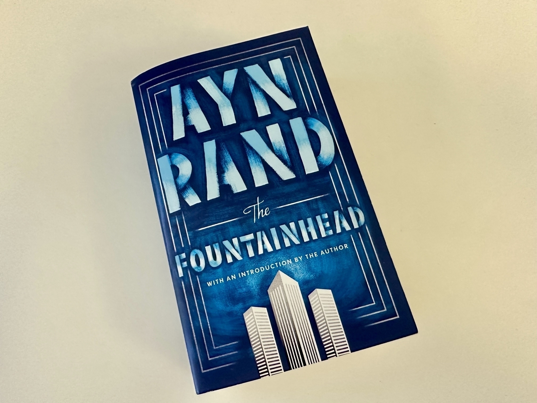 A copy of Ayn Rand's novel 'The Fountainhead' is lying on a flat surface.