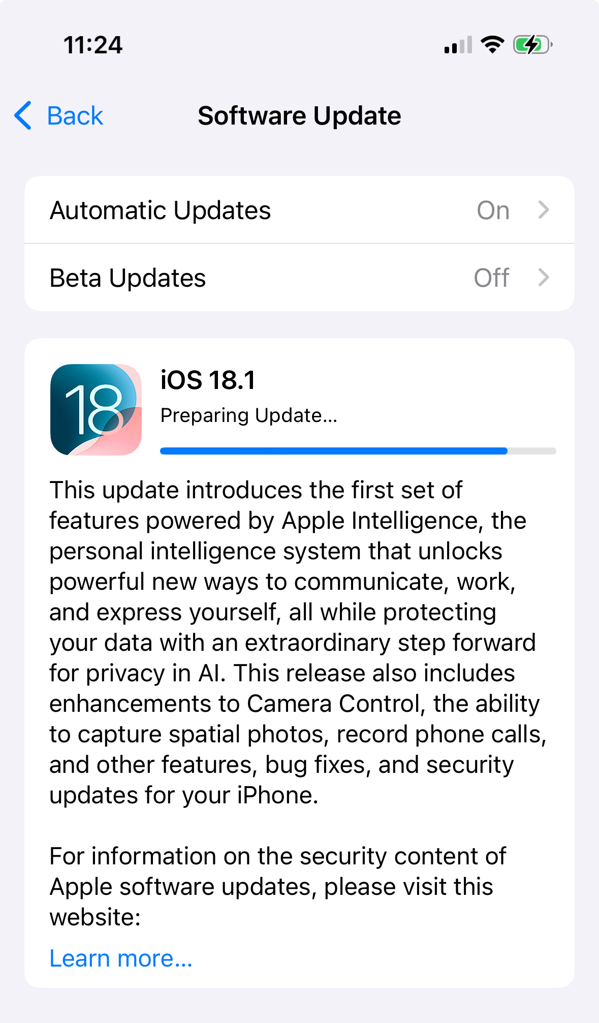 An iPhone software update screen shows the preparation of iOS 18.1, highlighting features related to Apple Intelligence and various enhancements.