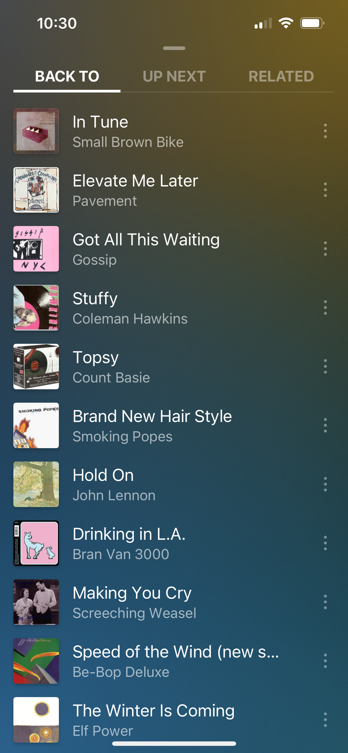 A Plexamp music playlist is displayed on a screen featuring various songs and artists.