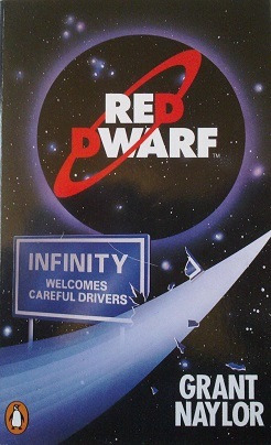 Book cover with Red Dwarf logo in a vague planetary circle above a free way style sign which reads “Infinity welcomes careful drivers”. One corner of the sign appears broken with pieces floating off from what looks to be a vapor trail from supposedly an unseen space ship. The authors name is in the lower right Grant Naylor.
