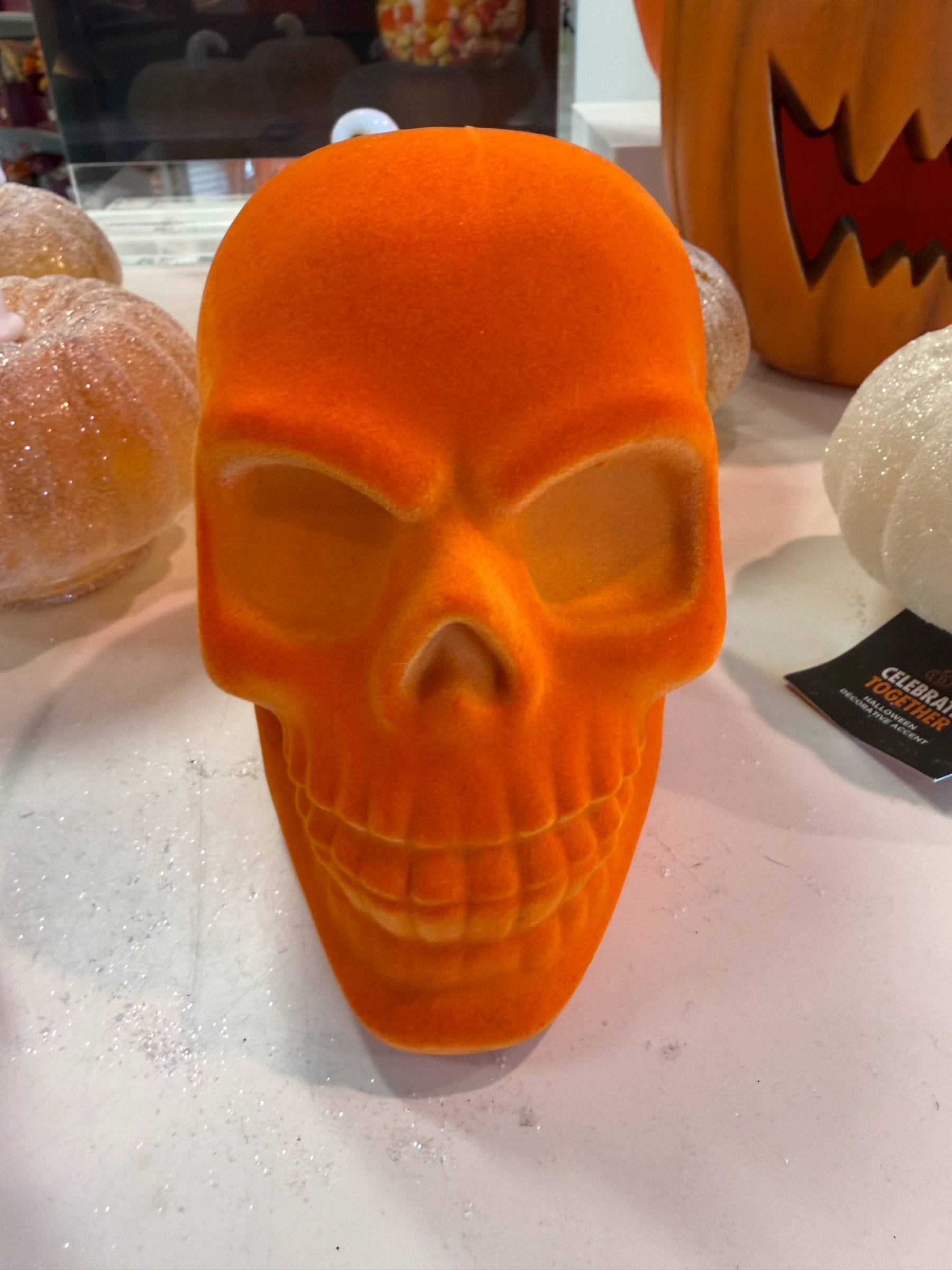it may not be johnny blaze, but this orange velour skull, sitting defiantly on a white table in a kohl’s entry way surrounded by inoffensive run of the mill suburban mom halloween tat will haunt your dreams.