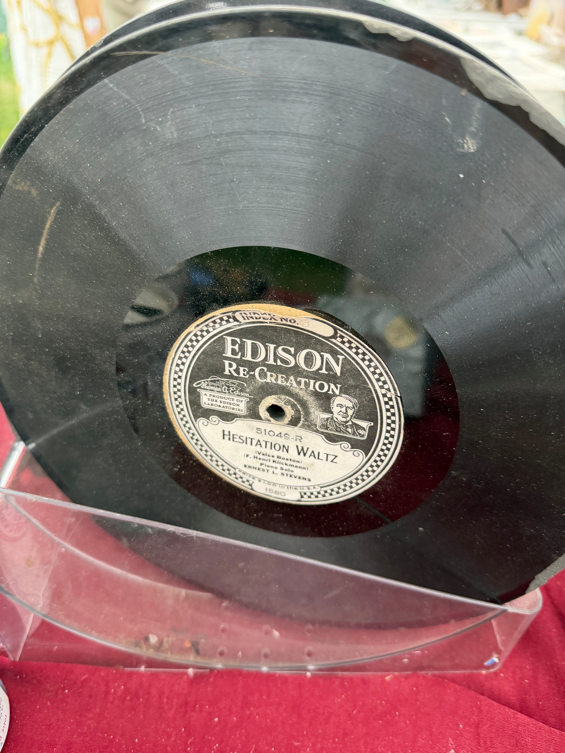A vintage Edison Re-Creation record titled Hesitation Waltz is displayed in a protective sleeve.