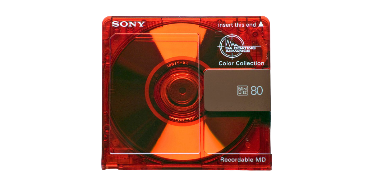 A red Sony MiniDisc with an 80-minute recording capacity is shown against a black background.