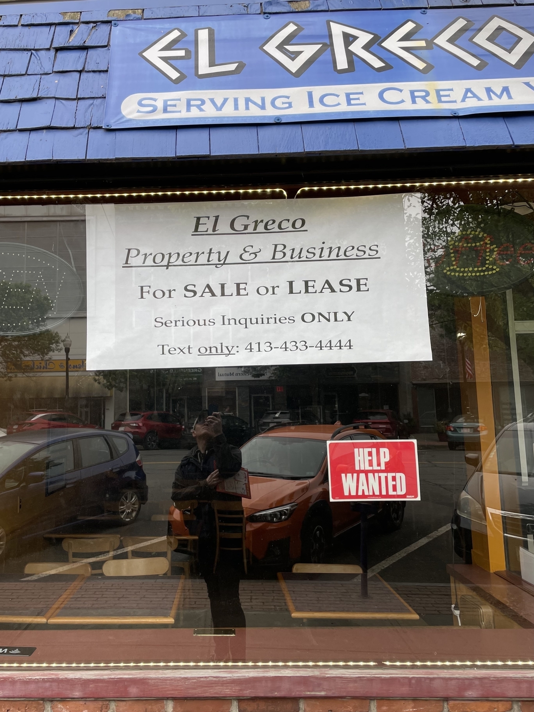 For sale sign in the window of El Greco restaurant in Greenfield MA
