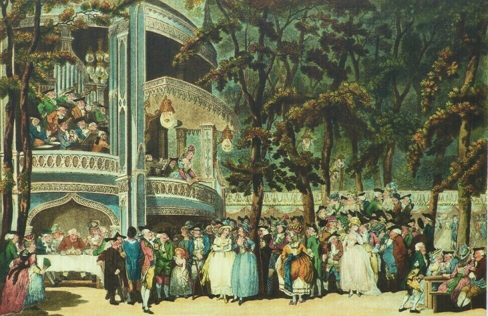 Auto-generated description: A lively outdoor gathering features a crowd of people in formal attire enjoying music and conversation amidst trees and a pavilion.