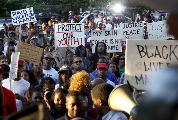 Protestors listen during a rally against what demonstrators call police brutality in McKinney, Texas, June 8, 2015. REUTERS/Mike Stone