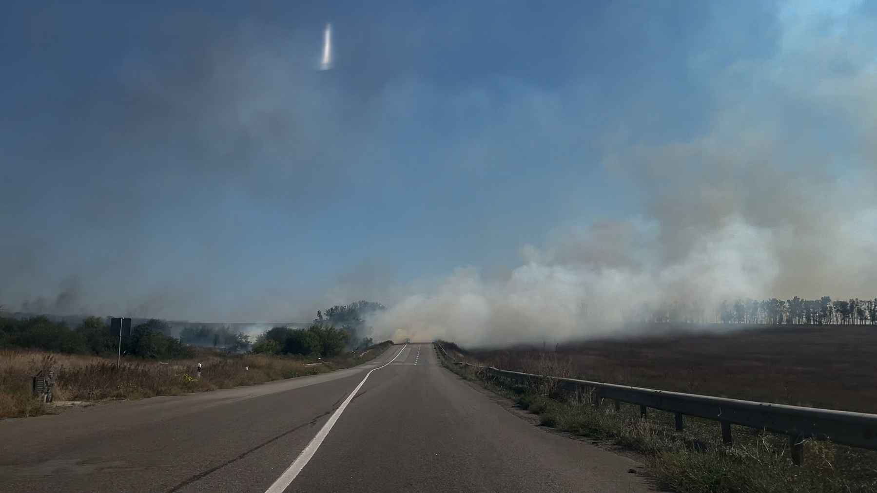Izium-Sloviansk highway with a smoke rising from the hills burnt by Russian attacks. Sep. 7, 2025