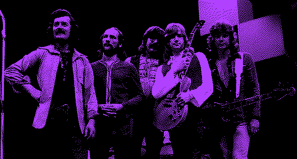 Grainy black and purple photo of the Moody Blues from the late 60s. Justin Haywood holds a guitar, as does John Lodge.