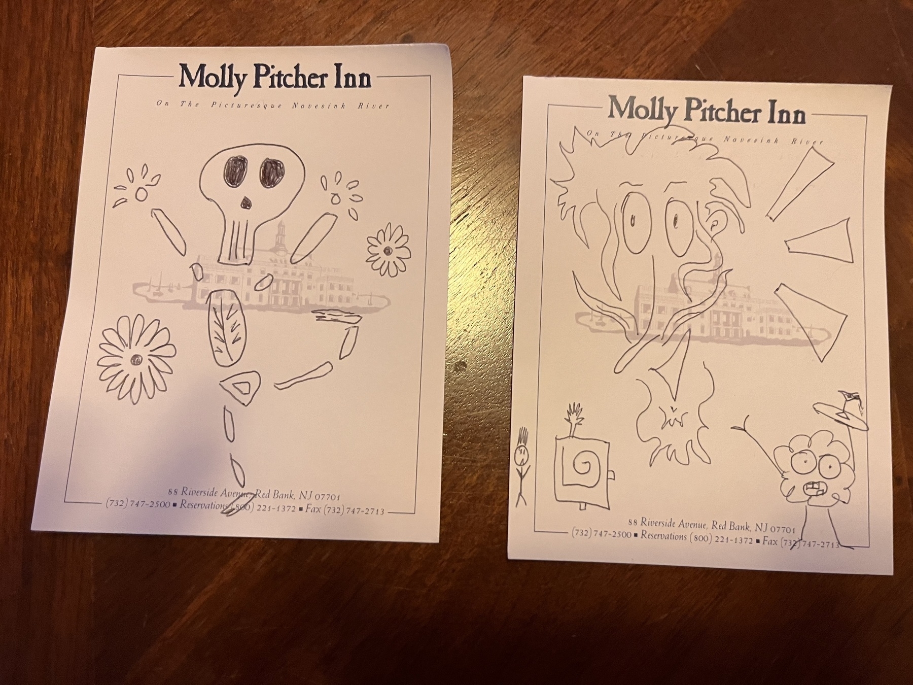 Two doodles on small pieces of paper. One is a skeleton prancing with some flowers around. The other is a whimsical bearded crazy hair face who’s smiling. 