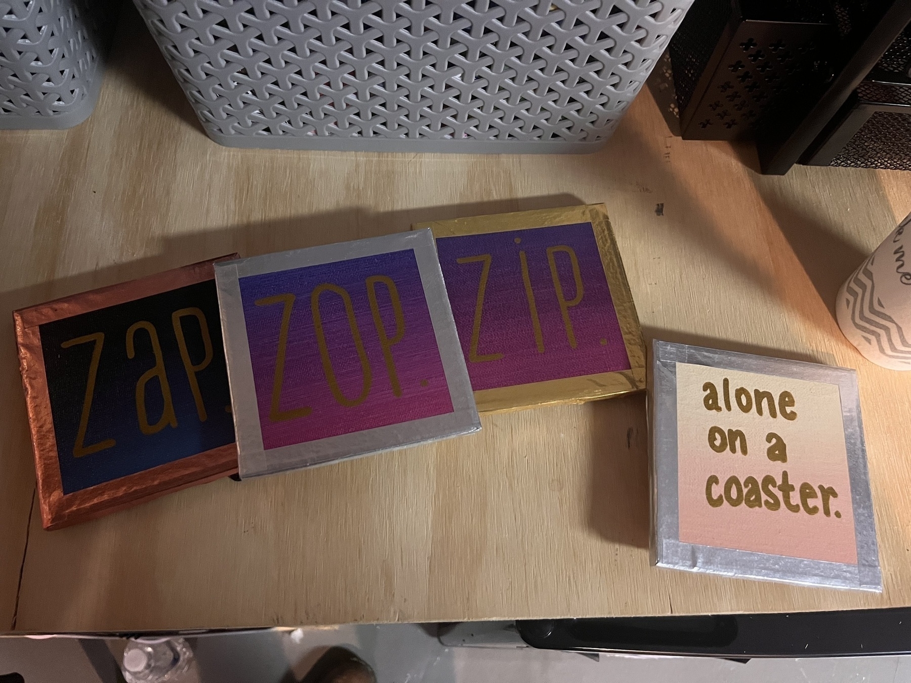 Three Coasters that say zip, zap, and zop. 