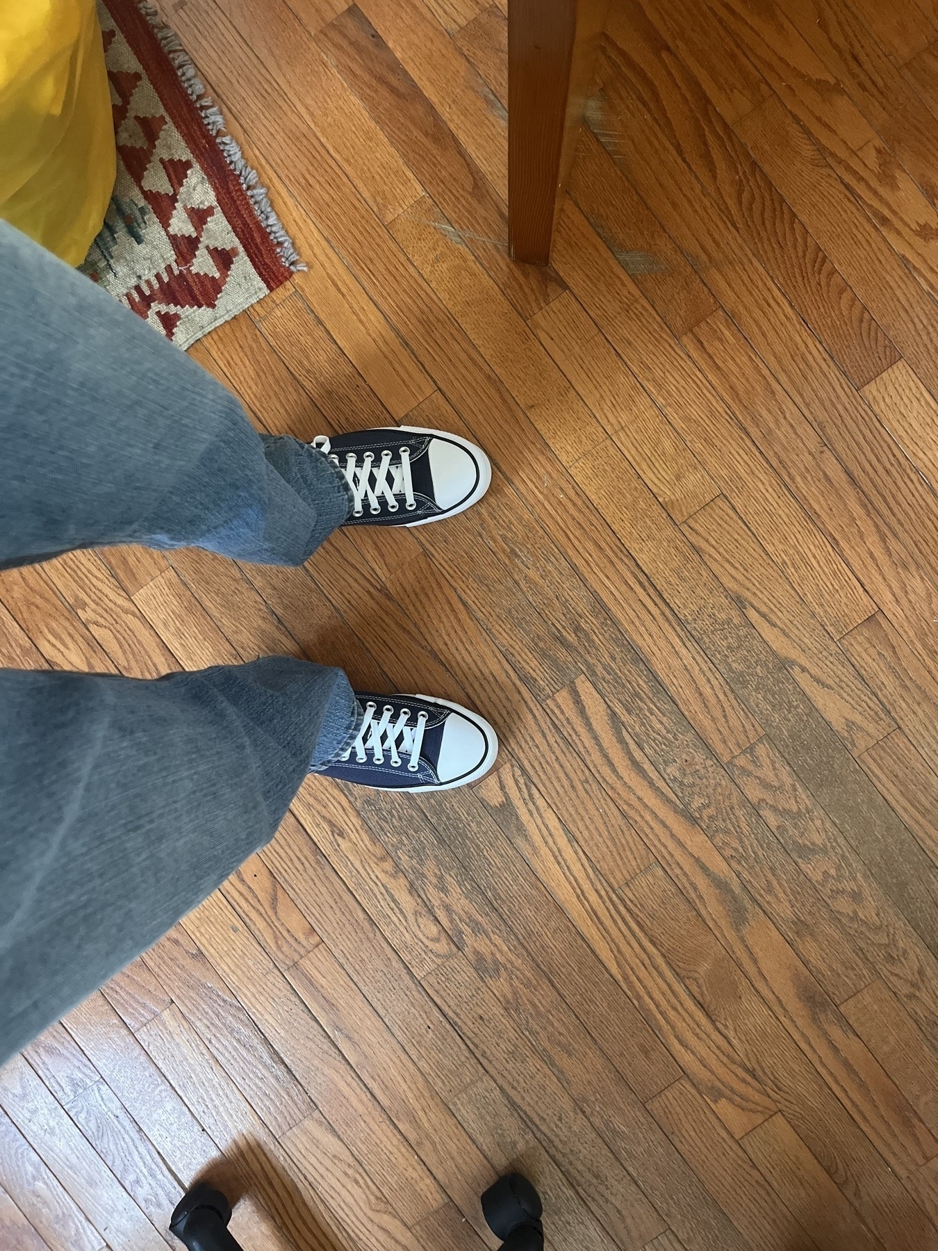 A shot of my legs in jeans and blue converse on my feet. 