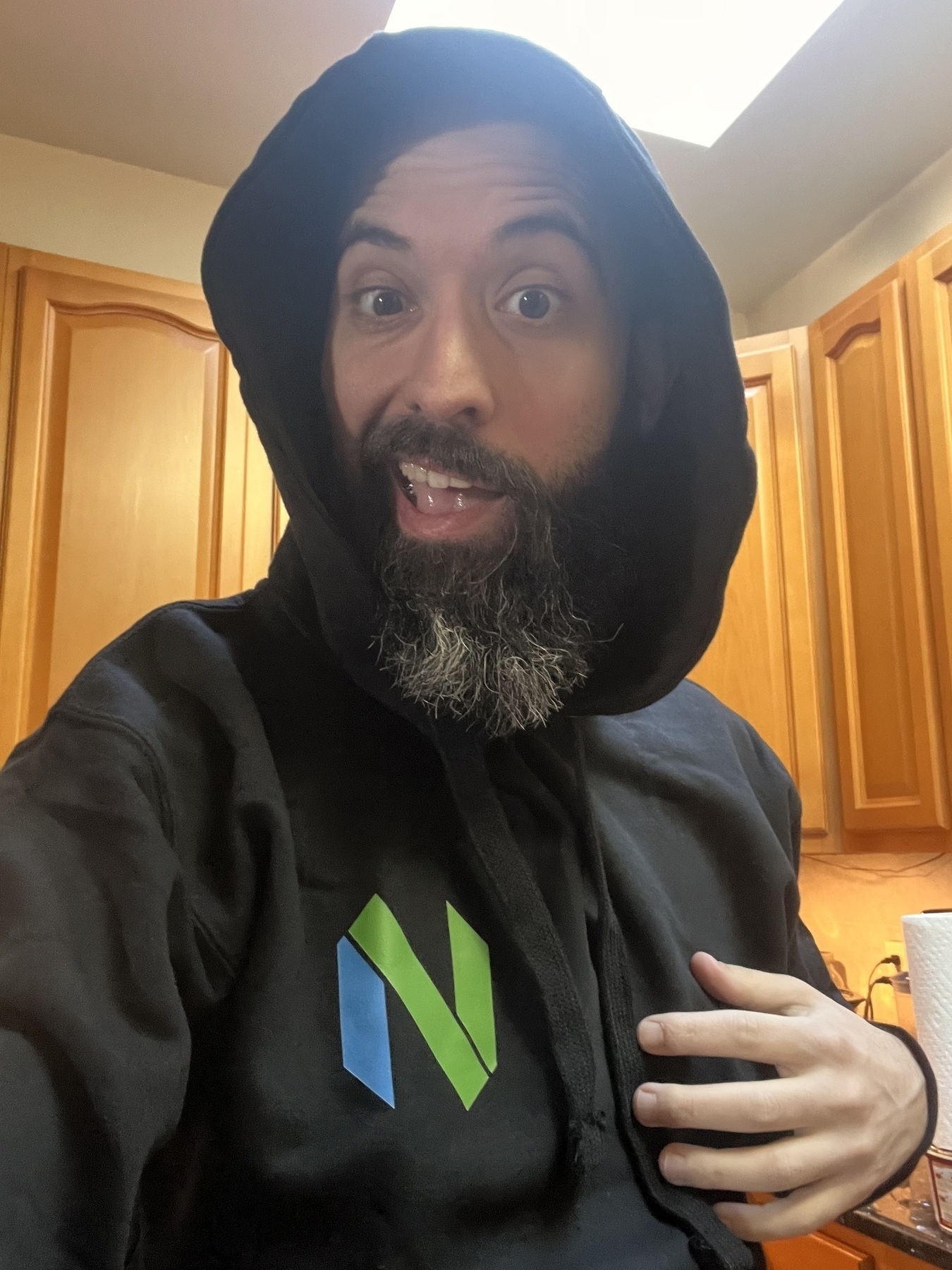 Me, an aging white guy, wearing a black hoodie with the Neovim symbol on the front. 