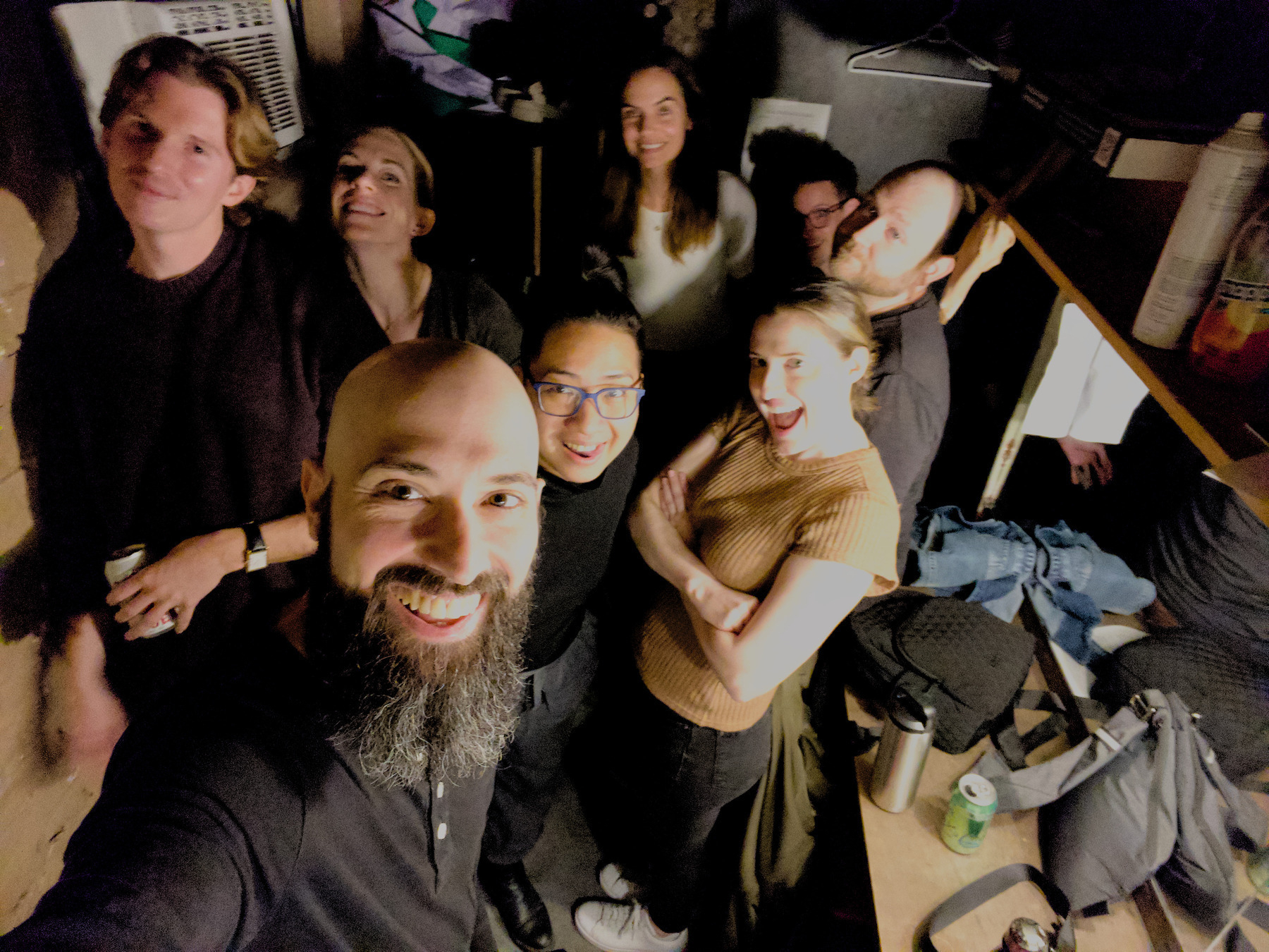 Auto-generated description: A group of people are gathered in a room, smiling and posing for a photo.