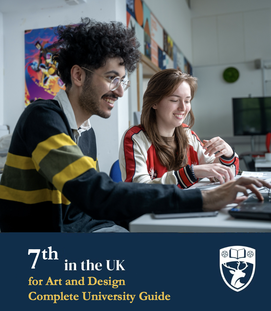 Two smiling students are working together on a computer in a creative, colorful environment promoting a university ranked 7th in the UK for Art and Design.