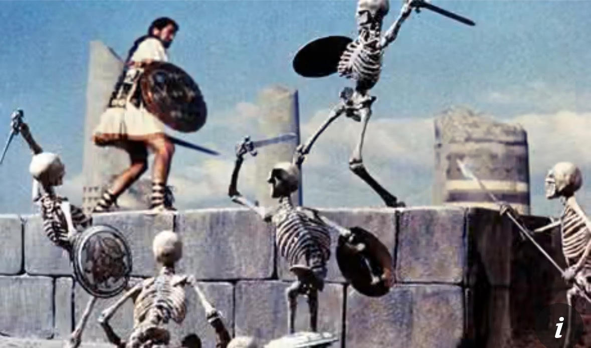 Jason with a shield and sword is fighting against multiple skeleton warriors on a stone structure. From the film Jason and the Argonauts. 