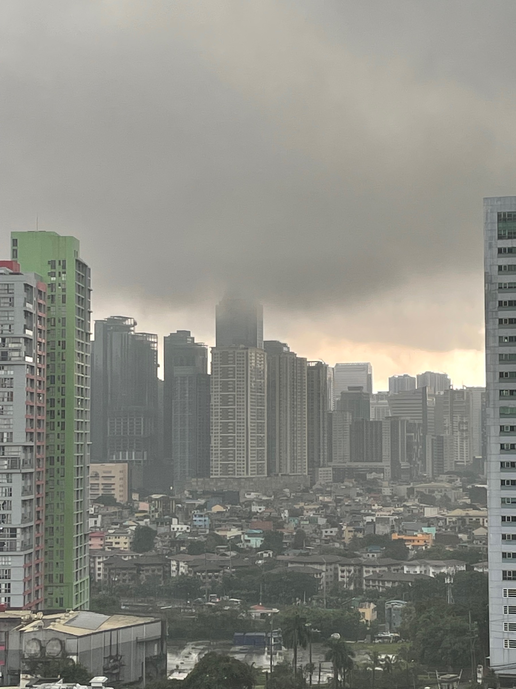 A peek out of Chi's window, where the rain clouds look lower than usual, obscuring the usual city skyline you'd see from the central business district where she lives.