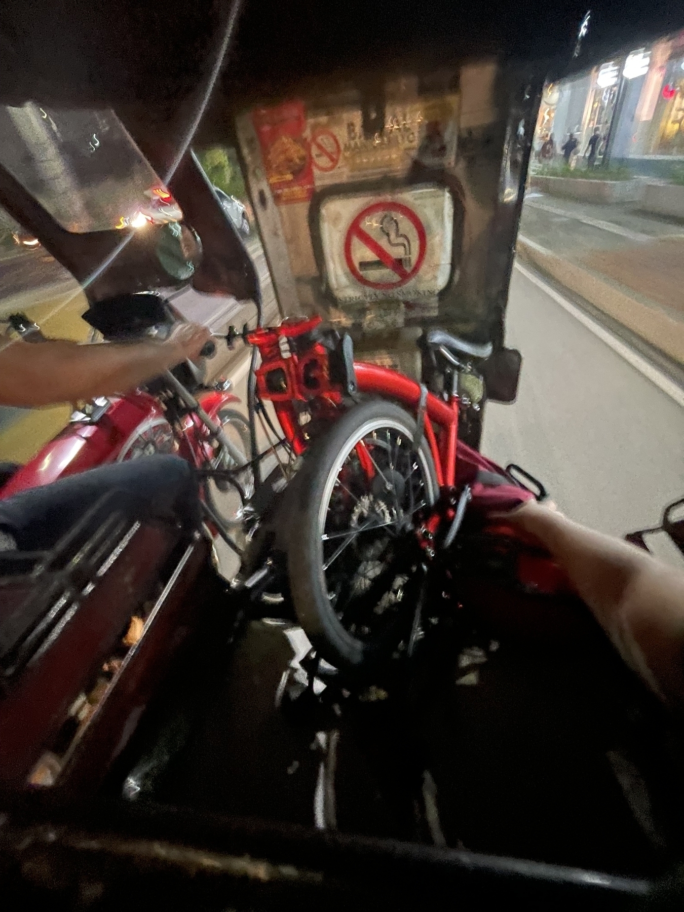 Chi’s folding bike in the middle of a tricycle’s cabin, folded neatly to fit within the seat. Chi’s bag, which usually is attached to the front of the bike, is found on the right side of the bike, near the tricycle’s entrance, to help keep it in place as the trip goes on.