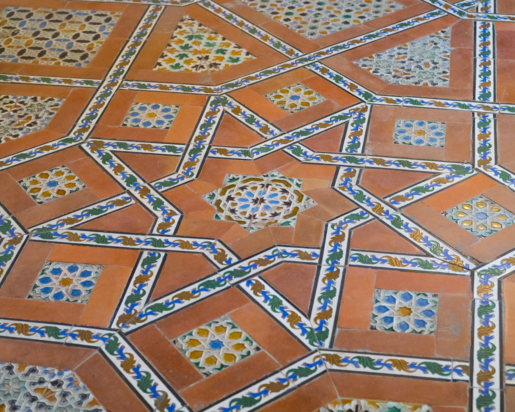 An ornate floor of bright patterns inside geometric shapes.