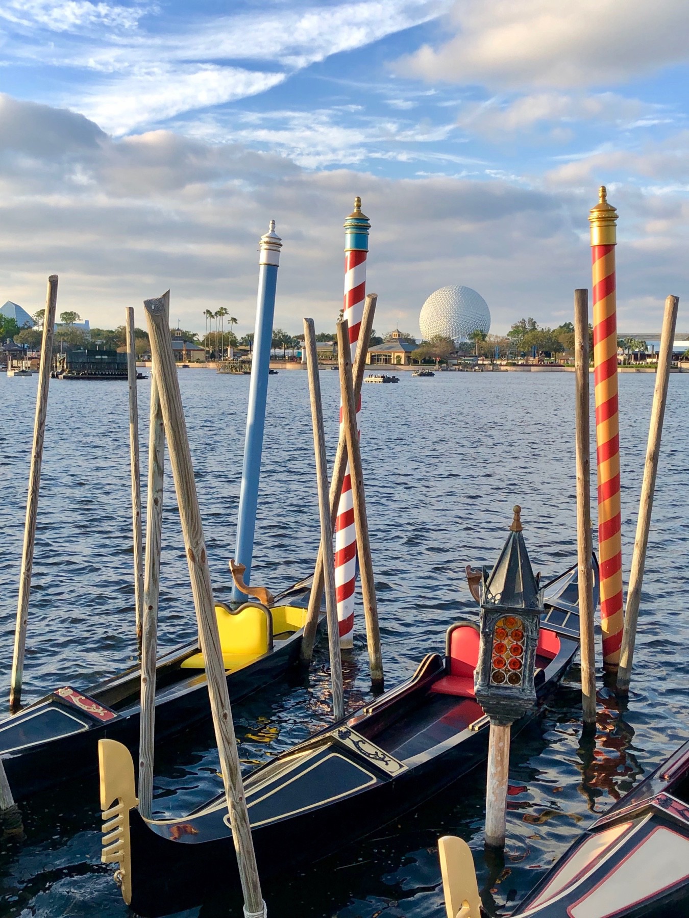 A small grouping of Italian gondolas at the bottom with Spaceship Earth in EPCOT seen near the top in the background.