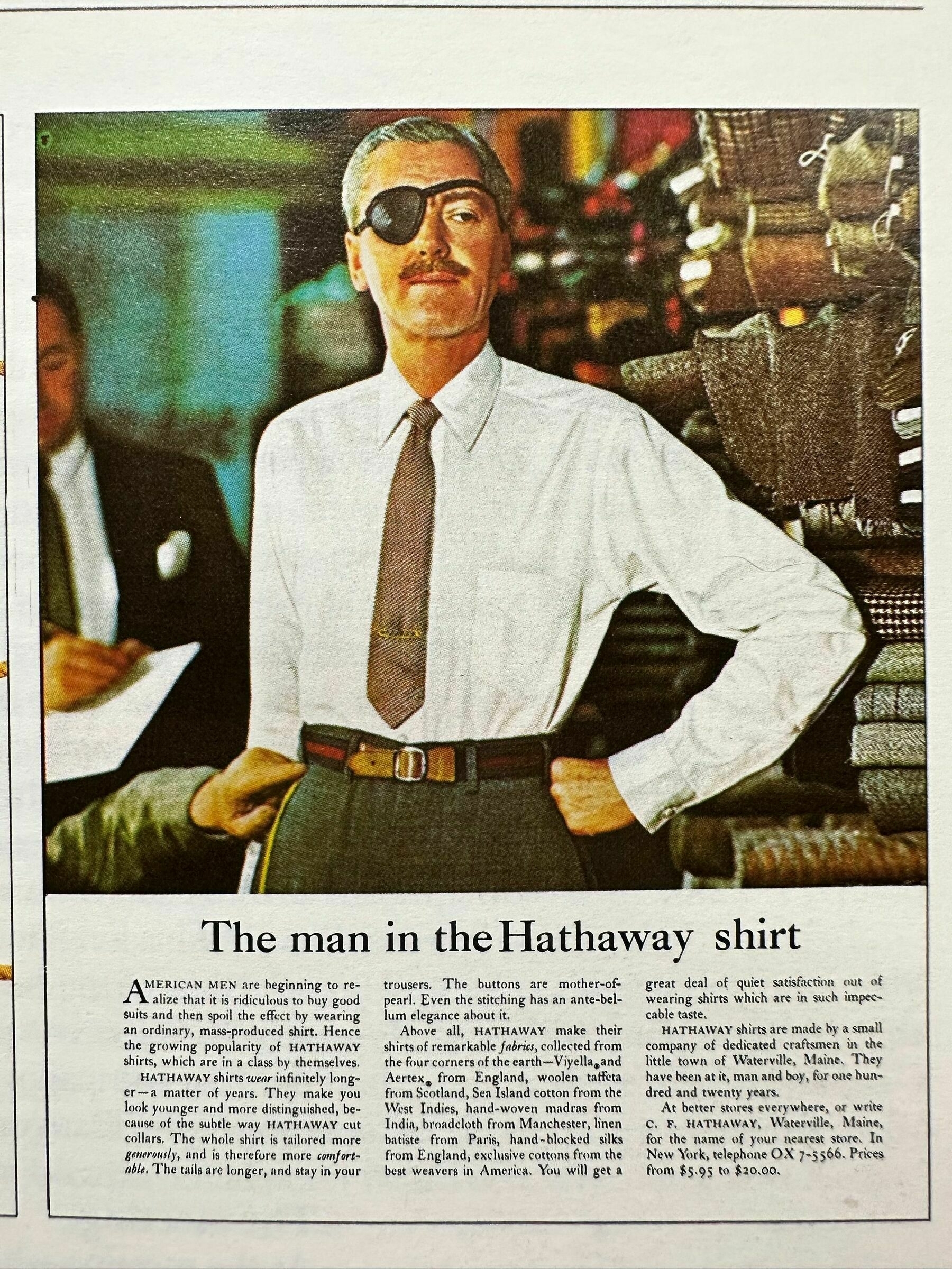 David Ogilvy's classic The man in the Hathaway shirt ad featuring a well tailored man standing in a suit store getting measured and wearing an eye patch.